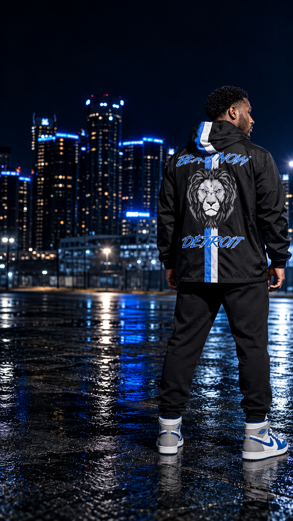 Model wearing the black BeastNOW Detroit windbreaker in downtown Detroit at night